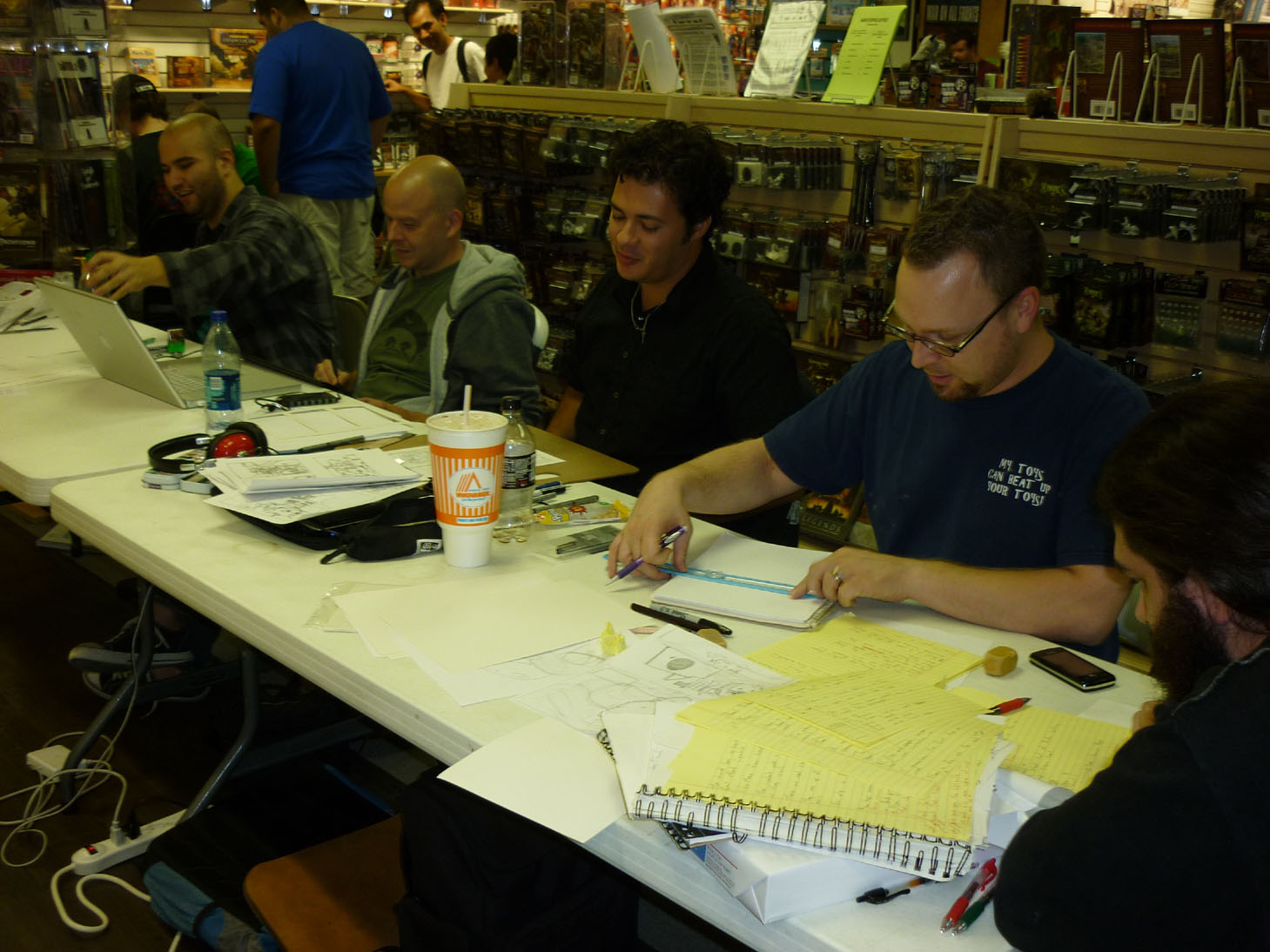 (L. to R) Bonn Adame, Erik Kuntz, Justin Rogers and Jeremy Guyton create at their table during 24 Hour Comics Day in Austin, Texas.